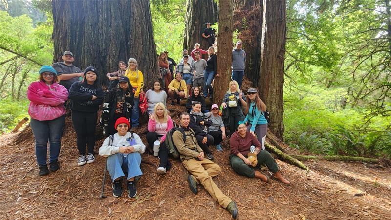 Group of students posing in front of trees.