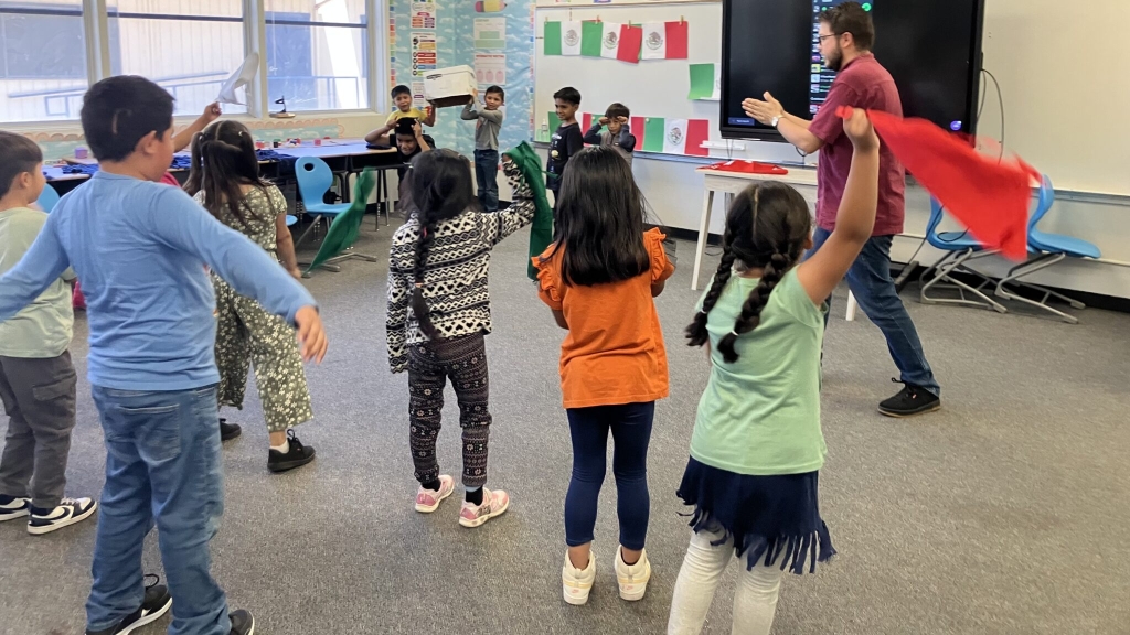  Young students standing in a classroom 