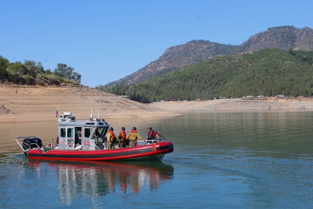 A fire boat cruises on the Pit River Arm of Shasta Lake.