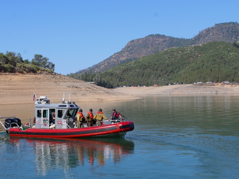 A fire boat cruises on the Pit River Arm of Shasta Lake.