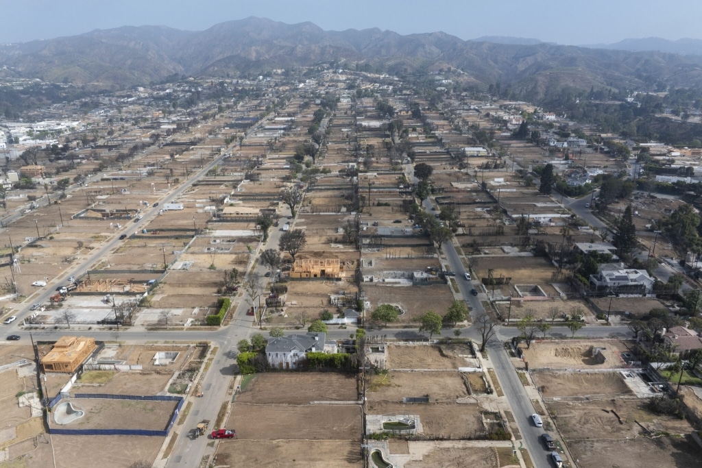 Aerial view of neighborhood with homes damaged from a fire. 