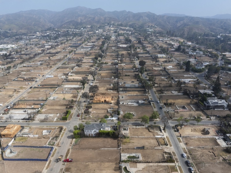 Aerial view of neighborhood with homes damaged from a fire.
