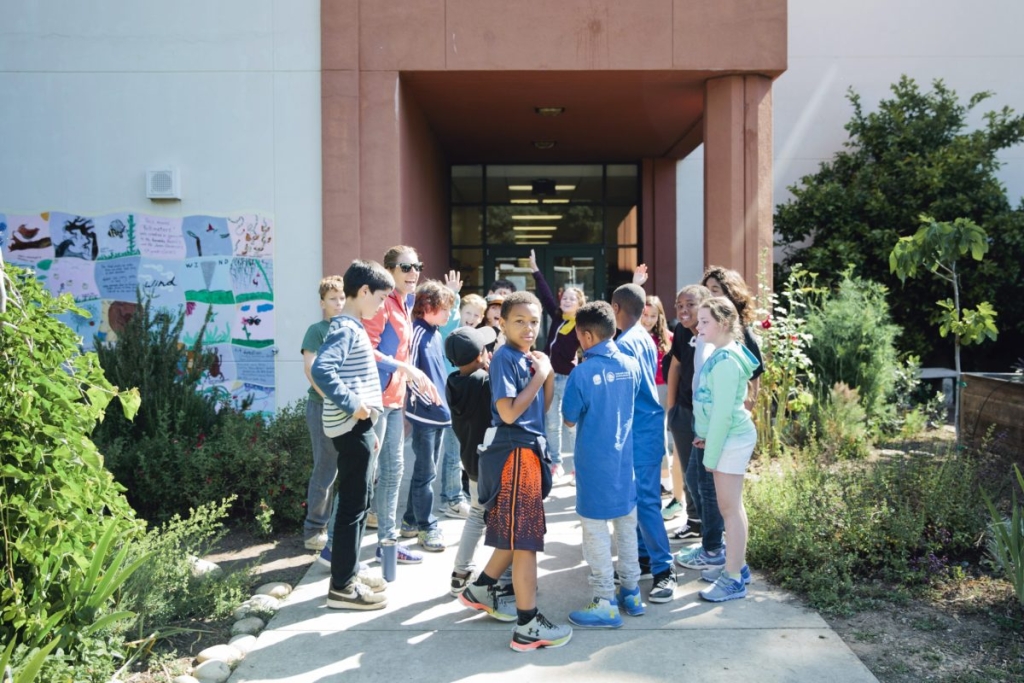 Group of kids standing outside of school