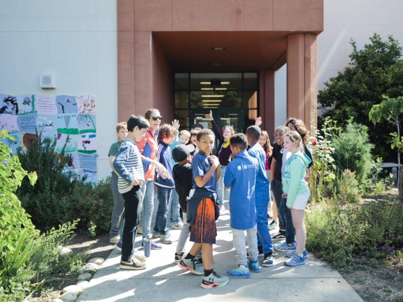 Group of kids standing outside of school