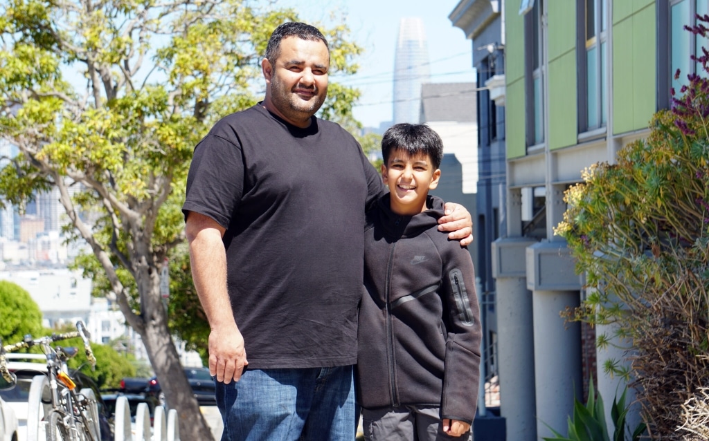 Father and son standing together outside of a school