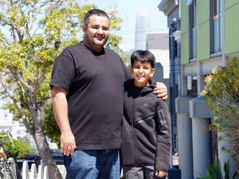 Father and son standing together outside of a school