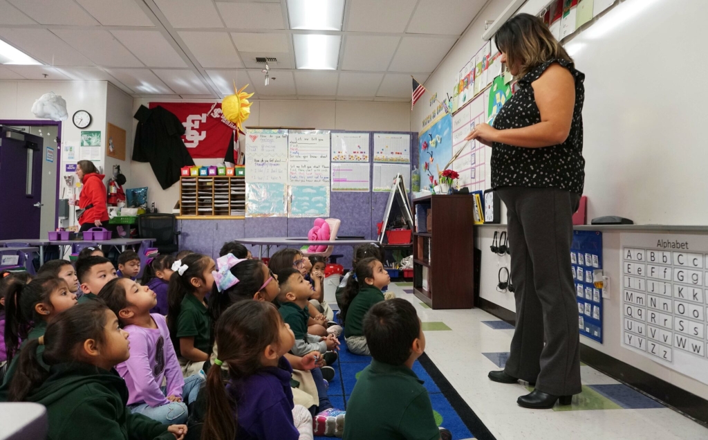 teacher standing in front of kindergarten class