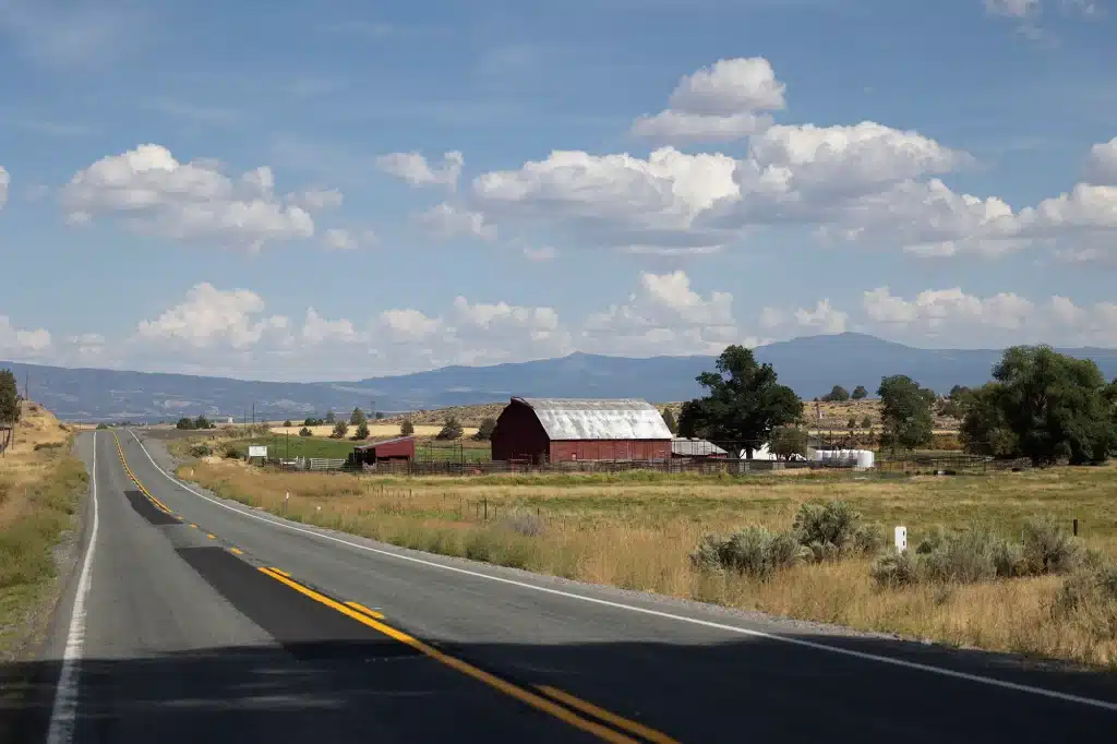 Barn on the side of the road with a field