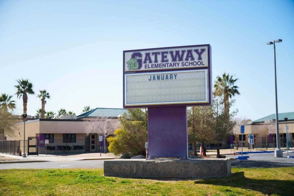 The front entrance to a school, with a sign in the center reading “Gateway Elementary School” and the month January spelled out below.
