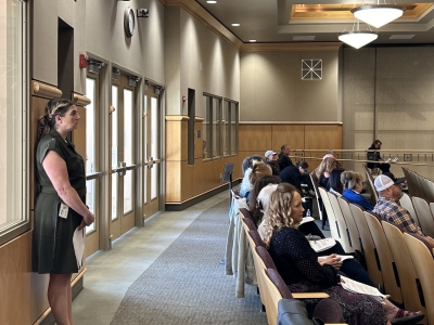 Former Assistant County Clerk and Registrar of Voters Joanna Francescut waits at the back of a boardroom in April 2024.